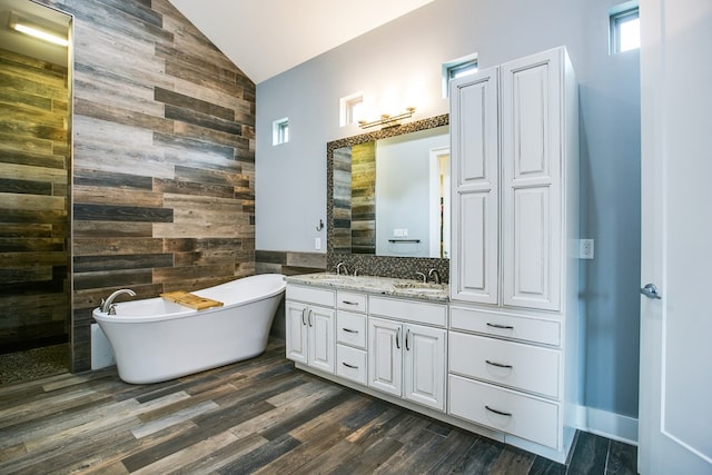 2118 Valleyview Dr, San Angelo, TX 76904 - full bath with wood walls, double vanity, a soaking tub, high vaulted ceiling, and wood finished floors