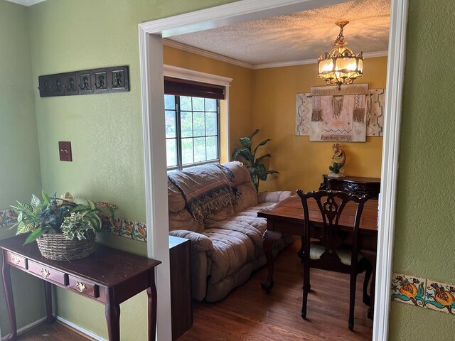 3826 Hillcrest Dr, San Angelo, TX 76904 - living room with ornamental molding, a notable chandelier, a textured wall, and wood finished floors