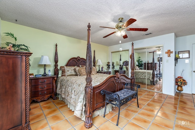 tiled bedroom featuring ceiling fan and a textured ceiling