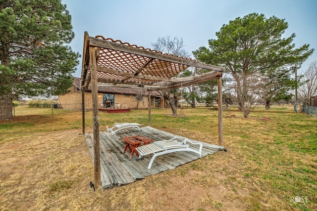 view of yard featuring a wooden deck and a pergola