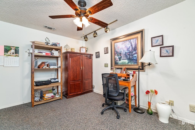 carpeted office with ceiling fan, rail lighting, and a textured ceiling