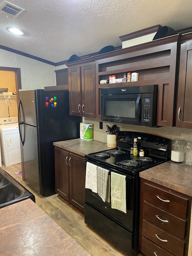 kitchen with washer / dryer, light hardwood / wood-style floors, black appliances, dark brown cabinets, and a textured ceiling