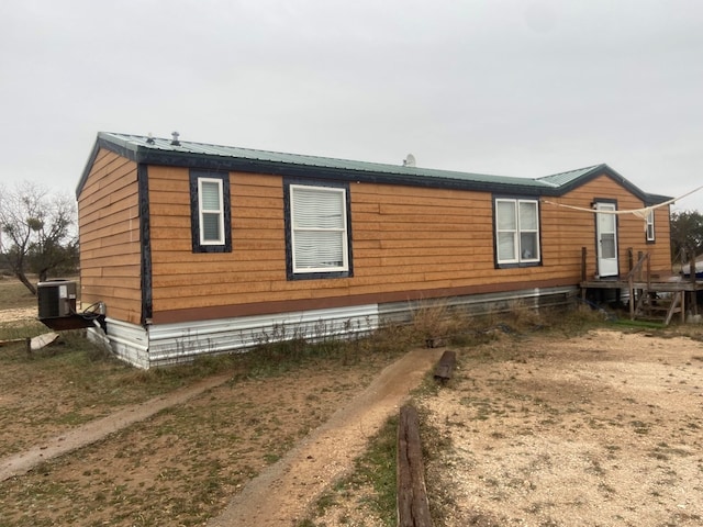 view of side of home featuring central AC unit