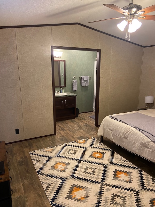 bedroom with crown molding, vaulted ceiling, hardwood / wood-style floors, and ceiling fan