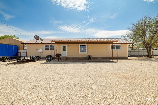 307 E 12th St, Big Lake, TX 76932 - back of property with a patio area, fence, and metal roof