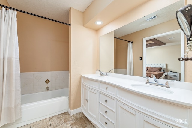 307 E 12th St, Big Lake, TX 76932 - full bathroom featuring ensuite bathroom, visible vents, double vanity, a tub to relax in, and a sink