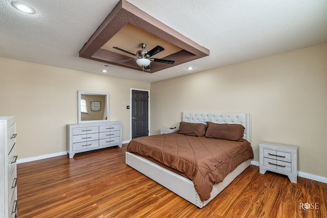 307 E 12th St, Big Lake, TX 76932 - bedroom featuring baseboards, visible vents, wood finished floors, and a textured ceiling