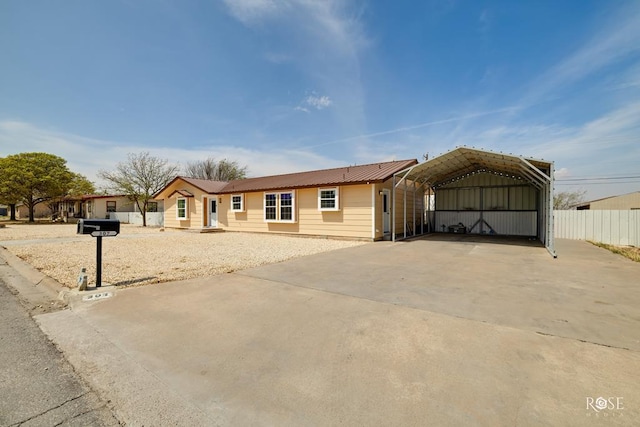 307 E 12th St, Big Lake, TX 76932 - single story home featuring a detached carport, fence, metal roof, and driveway