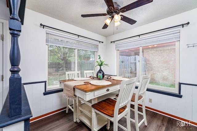 2509 1st Atlas St, San Angelo, TX 76905 - dining room featuring wood finished floors, a textured ceiling, ceiling fan, wainscoting, and baseboards