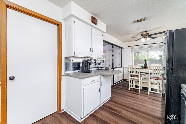 2509 1st Atlas St, San Angelo, TX 76905 - kitchen featuring freestanding refrigerator, white cabinetry, ceiling fan, a textured ceiling, and dark wood-style flooring