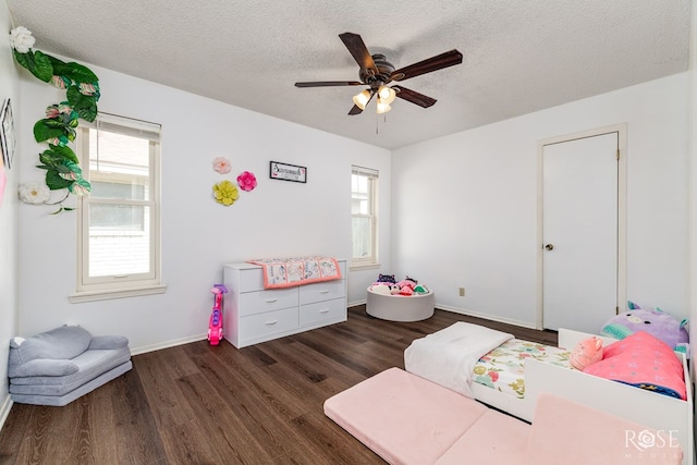 2509 1st Atlas St, San Angelo, TX 76905 - bedroom featuring wood finished floors, multiple windows, a textured ceiling, baseboards, and a ceiling fan