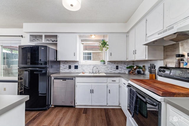 2509 1st Atlas St, San Angelo, TX 76905 - kitchen featuring range with electric cooktop, stainless steel dishwasher, freestanding refrigerator, a sink, and under cabinet range hood