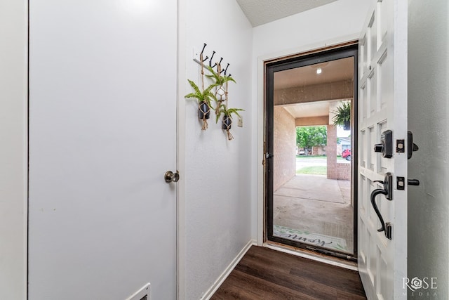 2509 1st Atlas St, San Angelo, TX 76905 - doorway featuring dark wood-style floors and baseboards