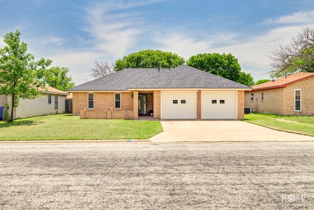 2509 1st Atlas St, San Angelo, TX 76905 - ranch-style home with brick siding, a garage, driveway, and roof with shingles