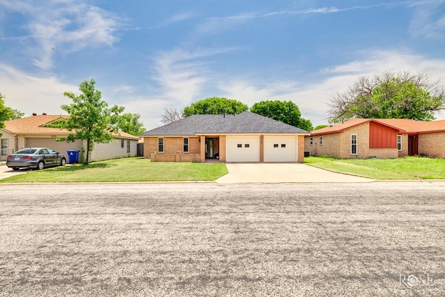 2509 1st Atlas St, San Angelo, TX 76905 - single story home with concrete driveway, an attached garage, a front lawn, and brick siding