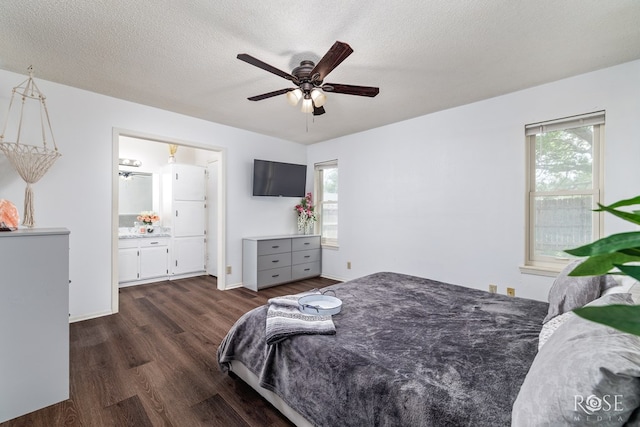 2509 1st Atlas St, San Angelo, TX 76905 - bedroom featuring dark wood finished floors, connected bathroom, a textured ceiling, and a ceiling fan