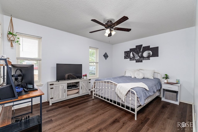 2509 1st Atlas St, San Angelo, TX 76905 - bedroom with wood finished floors, baseboards, an office area, and a textured ceiling