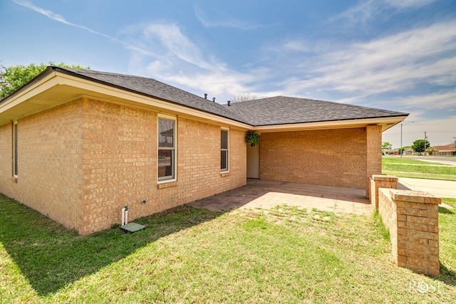 2509 1st Atlas St, San Angelo, TX 76905 - rear view of house with a lawn, brick siding, a patio area, and a shingled roof