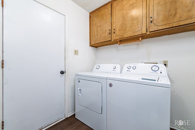 2509 1st Atlas St, San Angelo, TX 76905 - laundry room with washing machine and dryer, cabinet space, dark wood-style floors, and a textured ceiling