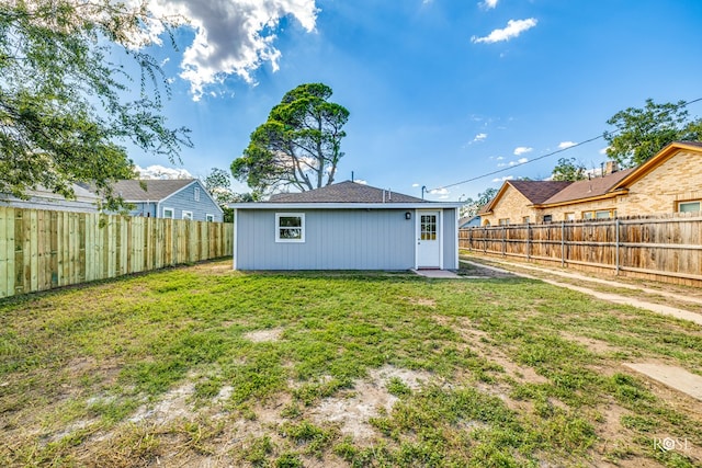 back of house with a lawn