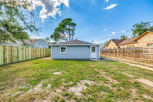 back of house with a lawn