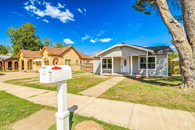 view of front of home featuring covered porch and a front yard