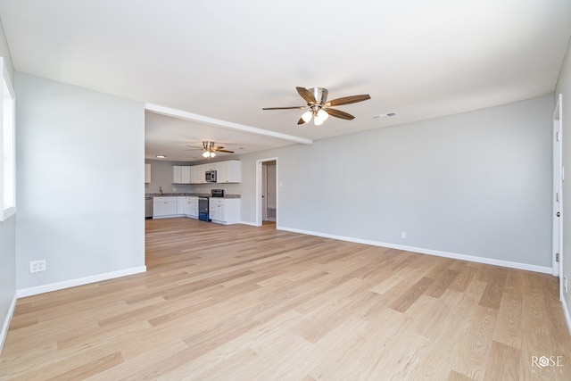 unfurnished living room featuring ceiling fan and light wood-type flooring