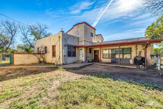 2318 Dallas St, San Angelo, TX 76901 - rear view of house with a patio, a gate, fence, and stucco siding