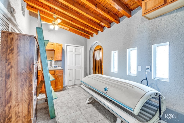 2318 Dallas St, San Angelo, TX 76901 - full bath with tile patterned flooring, a ceiling fan, a textured wall, wooden ceiling, and lofted ceiling with beams