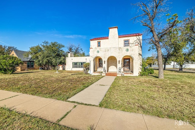 2318 Dallas St, San Angelo, TX 76901 - mediterranean / spanish-style house featuring covered porch, a chimney, a front lawn, and stucco siding