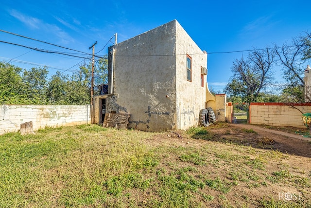2318 Dallas St, San Angelo, TX 76901 - view of side of property featuring fence, a gate, and stucco siding