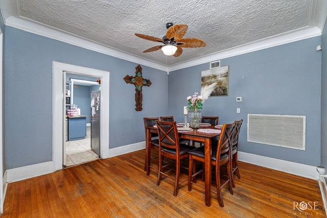 2318 Dallas St, San Angelo, TX 76901 - dining space with hardwood / wood-style floors, ceiling fan, a textured ceiling, and visible vents