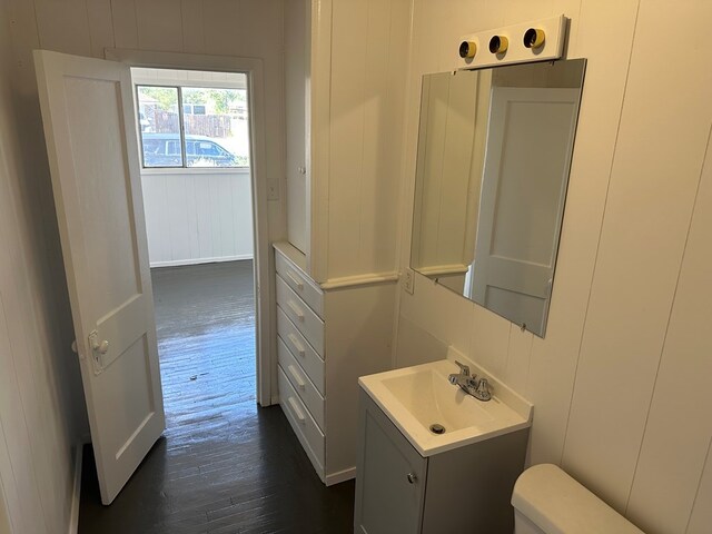 bathroom with vanity, hardwood / wood-style flooring, and toilet