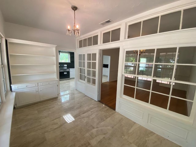 1001 S David St, San Angelo, TX 76903 - unfurnished dining area featuring a chandelier and french doors