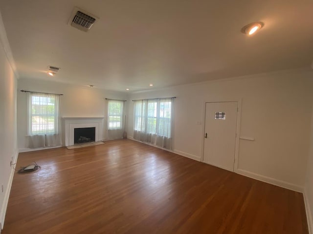 1001 S David St, San Angelo, TX 76903 - unfurnished living room featuring baseboards, wood finished floors, a fireplace with flush hearth, and recessed lighting