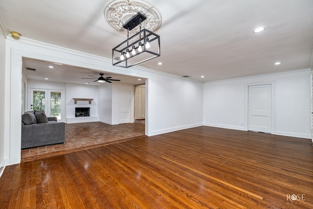 1510 Shafter St, San Angelo, TX 76901 - unfurnished living room featuring crown molding, a ceiling fan, a fireplace with raised hearth, recessed lighting, and dark wood-style floors