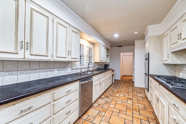 1510 Shafter St, San Angelo, TX 76901 - kitchen with appliances with stainless steel finishes, recessed lighting, backsplash, white cabinets, and dark stone counters