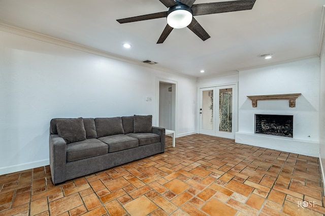1510 Shafter St, San Angelo, TX 76901 - living room featuring a ceiling fan, crown molding, a fireplace with raised hearth, and recessed lighting