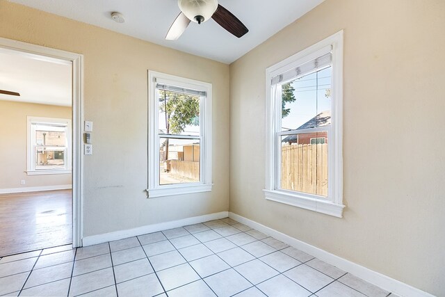 tiled empty room with ceiling fan