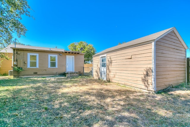 back of house with a yard and central AC