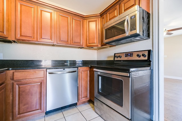 kitchen featuring stainless steel appliances and light tile patterned flooring