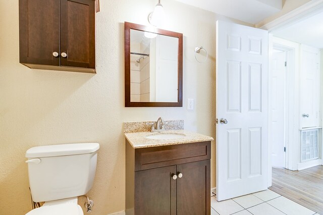 bathroom with tile patterned floors, vanity, and toilet