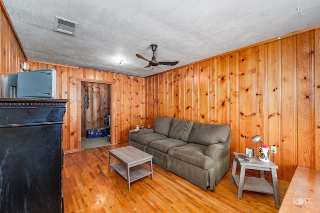 living room with hardwood / wood-style flooring and ceiling fan