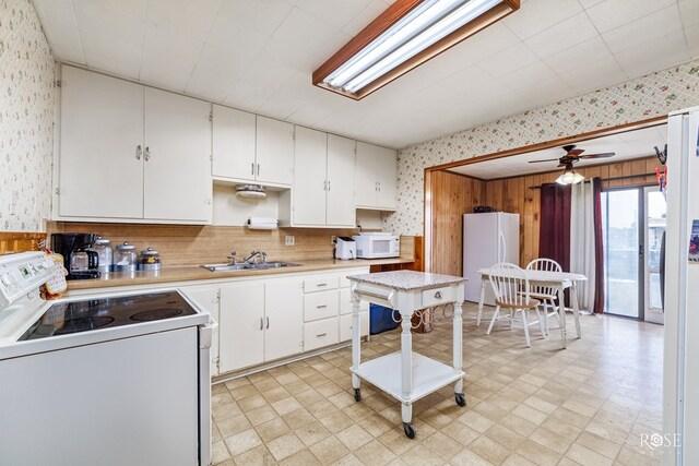 kitchen featuring ceiling fan, white appliances, sink, and white cabinets