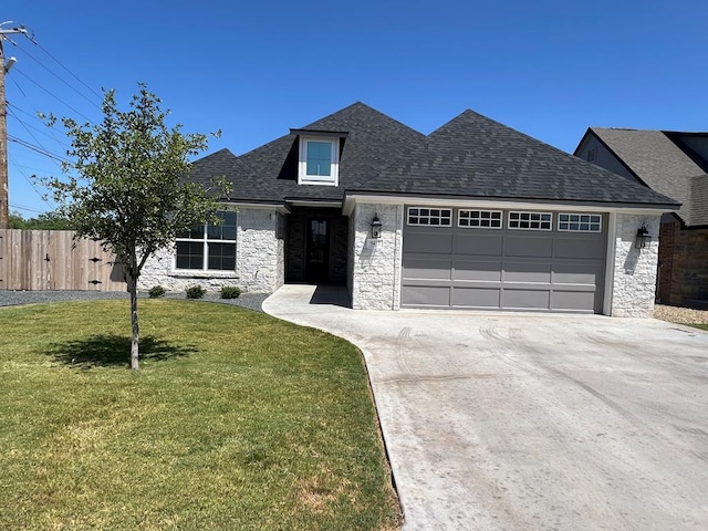 view of front facade with a garage and a front yard