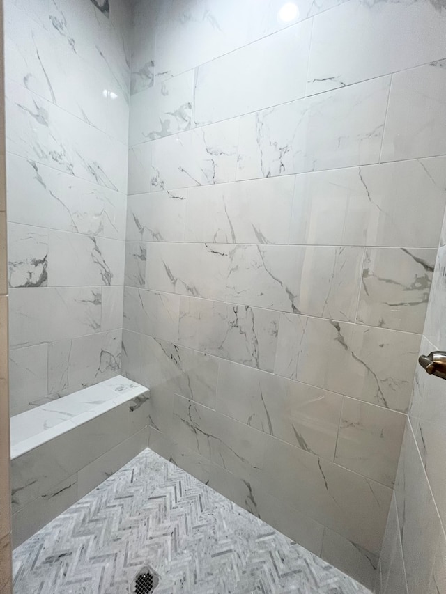 bathroom with tiled shower