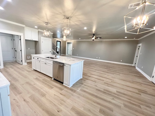 kitchen featuring dishwasher, a kitchen island with sink, white cabinets, and decorative light fixtures