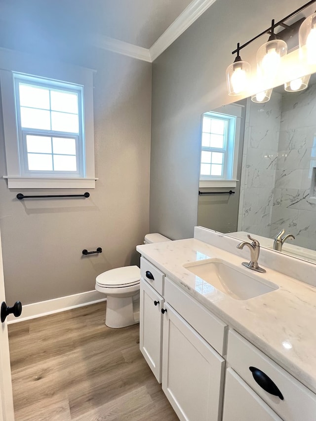 bathroom with crown molding, vanity, toilet, and hardwood / wood-style floors