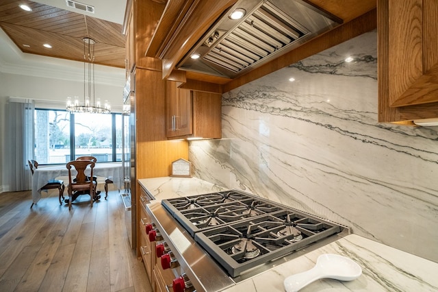 kitchen featuring premium range hood, crown molding, a notable chandelier, hardwood / wood-style floors, and decorative backsplash