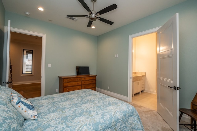 carpeted bedroom featuring connected bathroom and ceiling fan